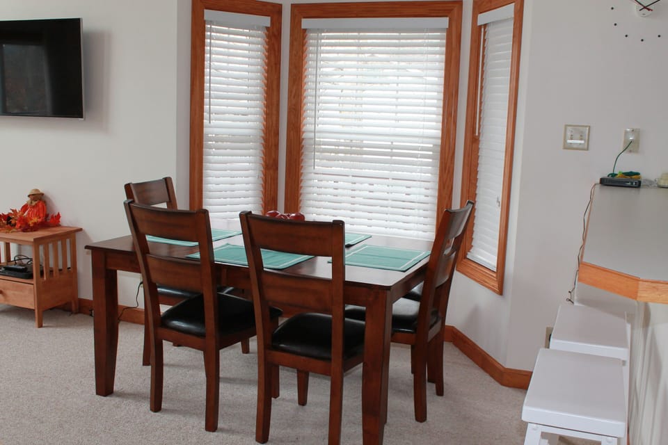 Table expands and can easily seat 10.  Three bar stools adjacent to table.