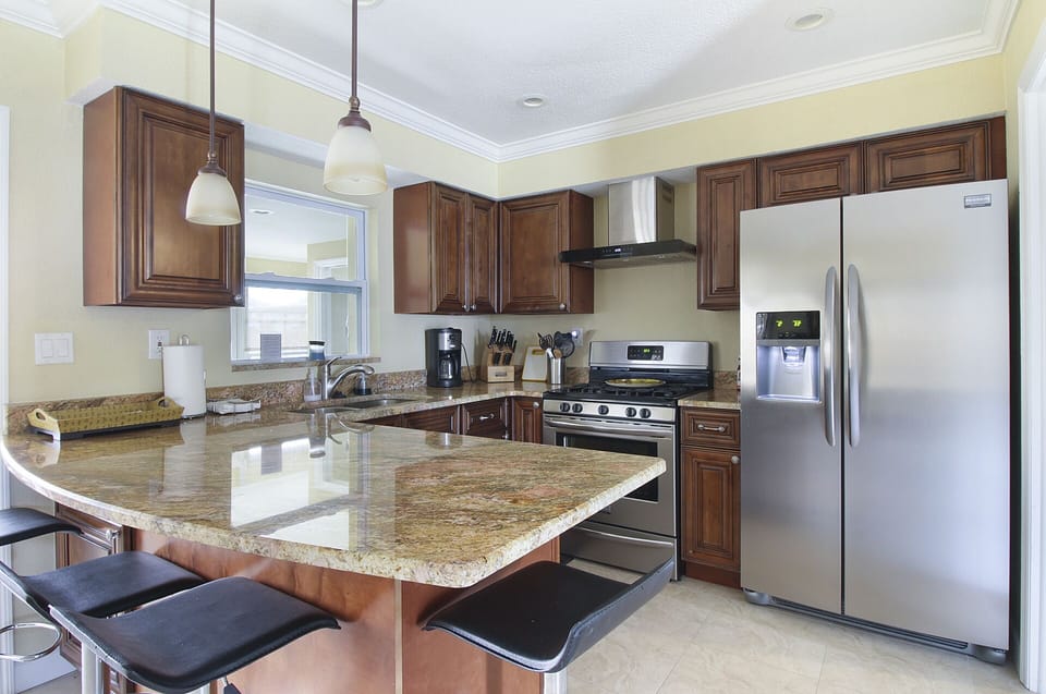 kitchen with stainless steel appliance and real wood cabinet