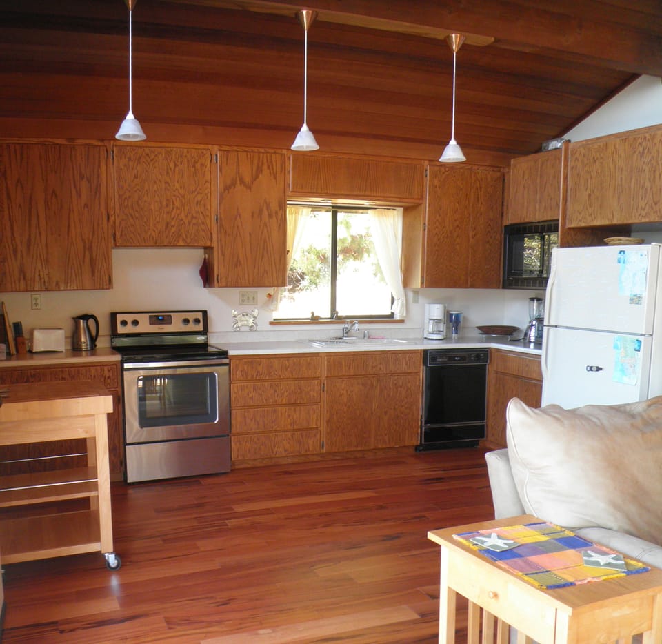 Kitchen with microwave, range, toaster oven, blender, coffee maker, and more..