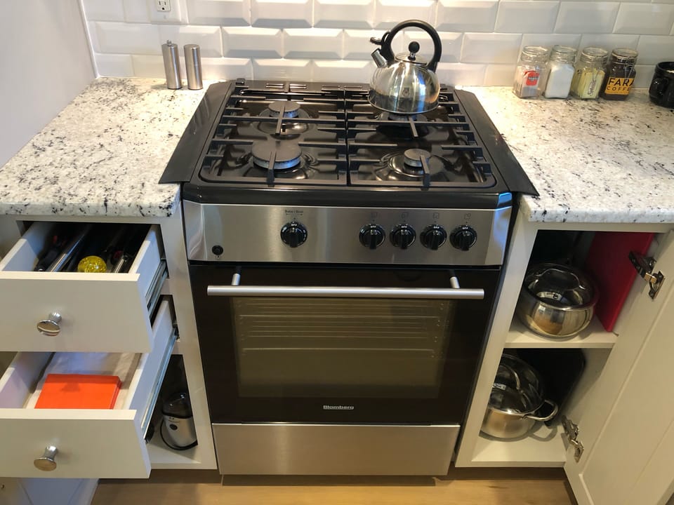 Cooking utensils, napkins, coffee bean grinder, European press, Blomberg range.
