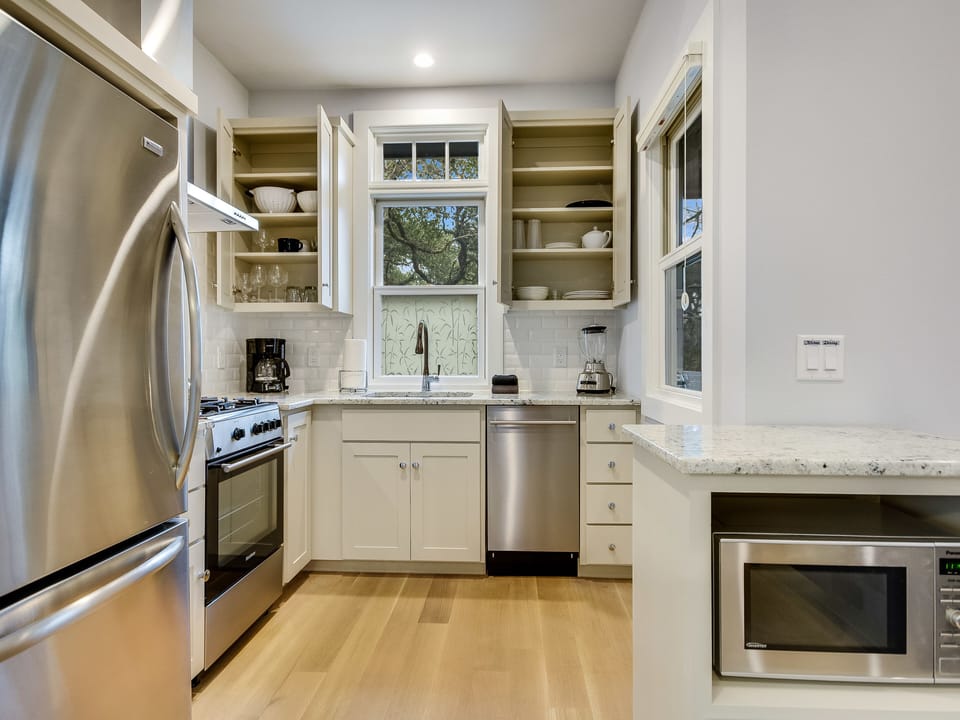 Completely outfitted kitchen, stainless appliances, micro island is on wheels.