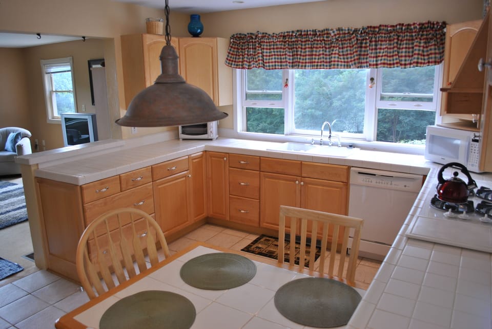 The light, airy kitchen/dining room opens onto the living room. 