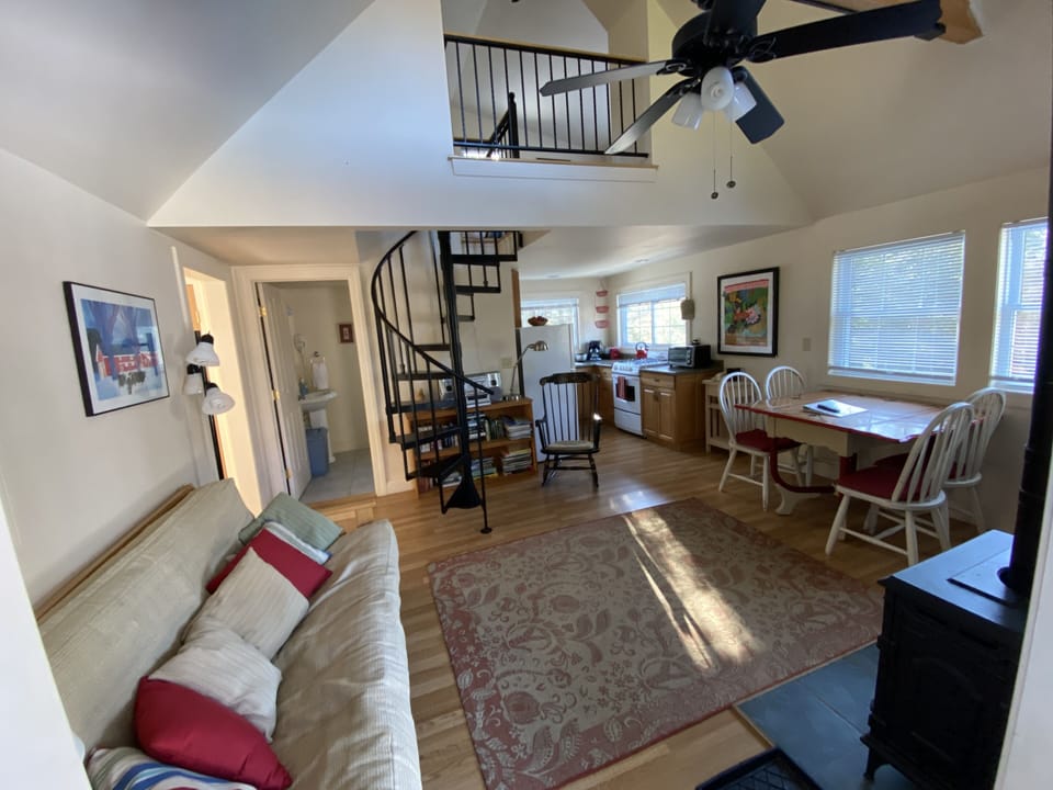 Sitting room w/futon sofa (opens to a double bed) spiral stairs to sleeping loft