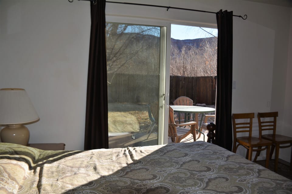 view to back yard patio from queen bedroom