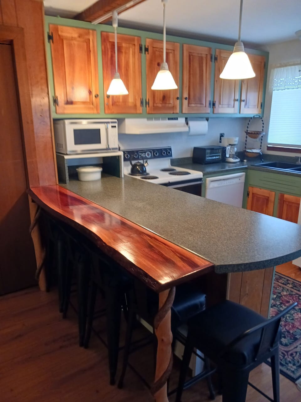 Kitchen with artisan countertop & cabinets.