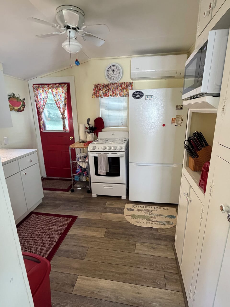 Mini split AC unit over refrigerator with remote.