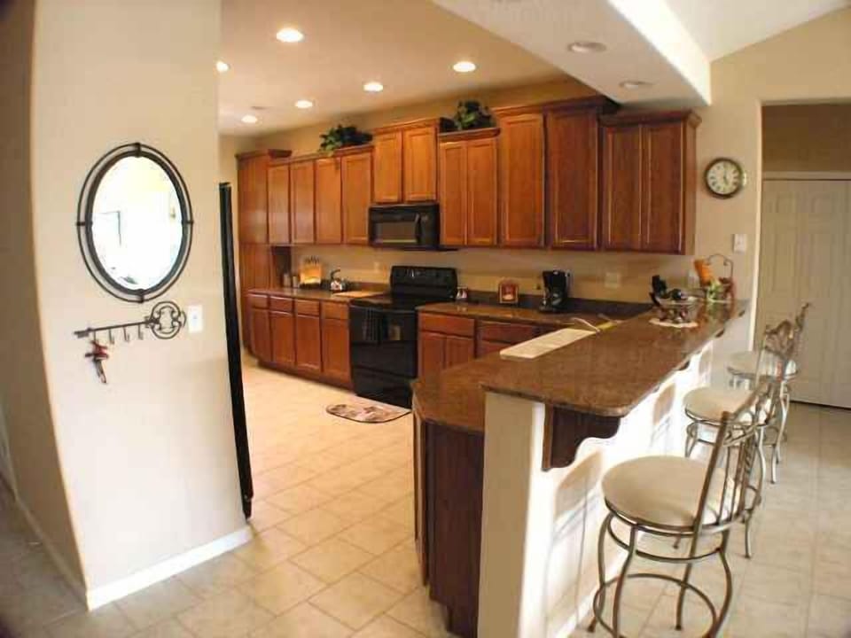 Large seated bar area with the washer and dryer closet just off to the right.