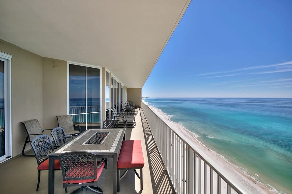 Large balcony with plenty of lounging and dining options. 