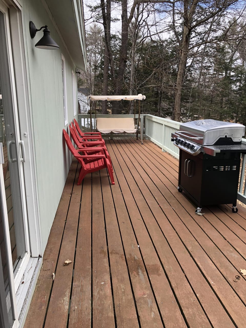 Deck with swing chair, 4 adirondack chairs and 6 burner grill 
