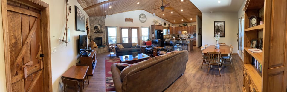 Panorama view of living area, kitchen, and dining areas.