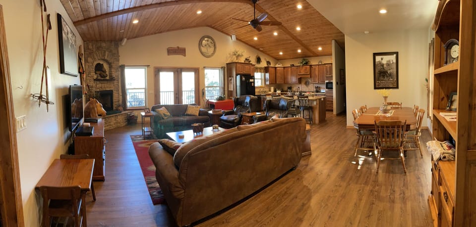 Panorama view of living area, kitchen, and dining areas.
