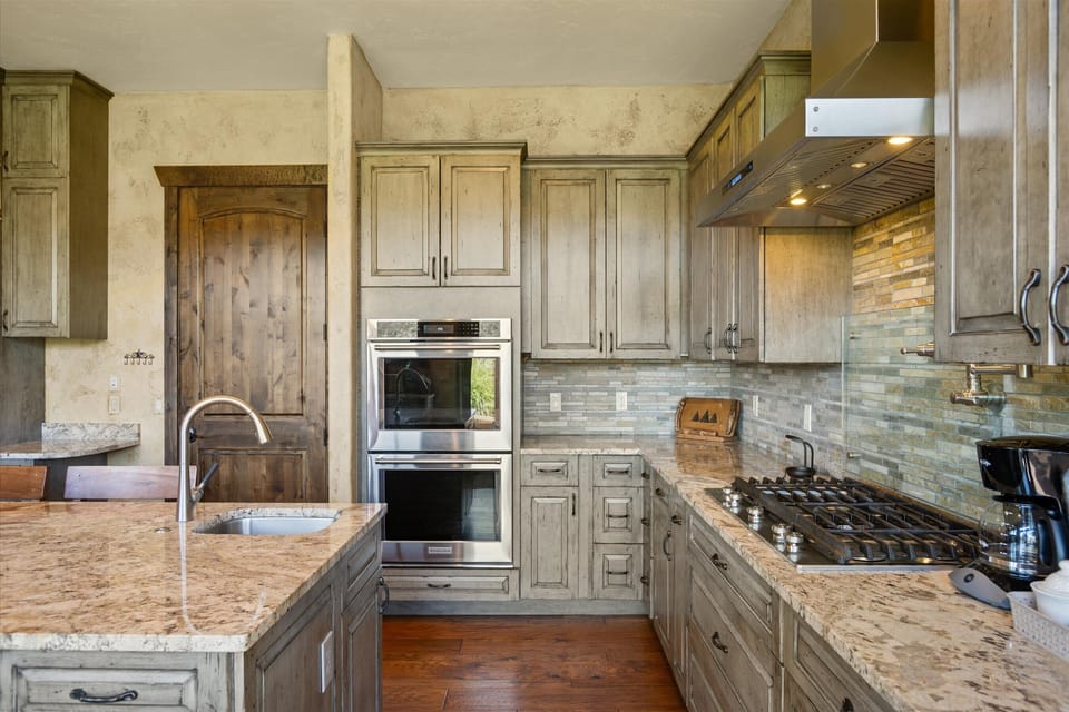 Kitchen has double ovens, gas cooktop, microwave