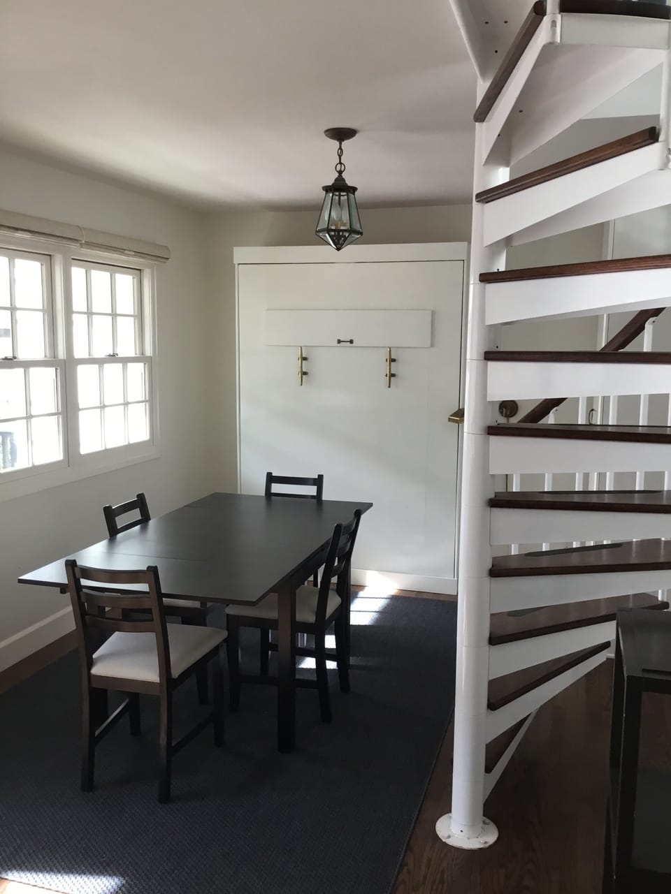 Dining area. Murphy bed against the wall. Full size bed.