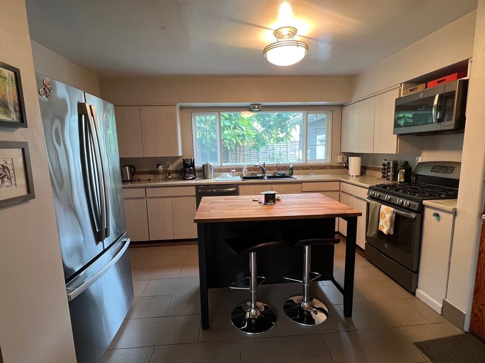 Kitchen with large Island, designer bar stools and open kitchen layout