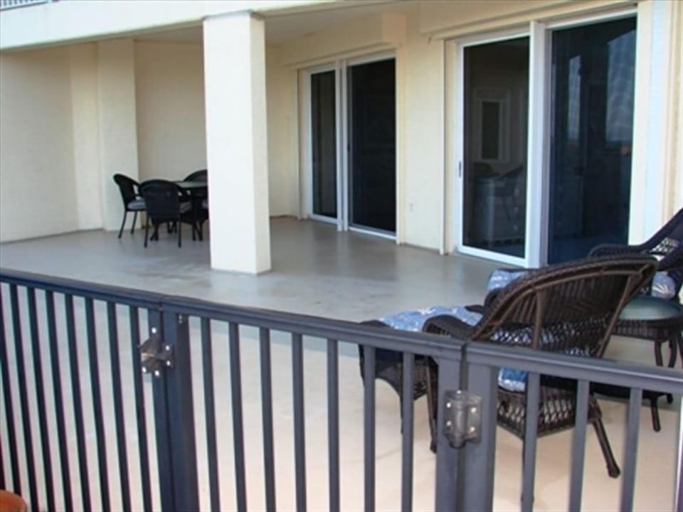 Oversized Patio with gate that leads to beach, pools and grill