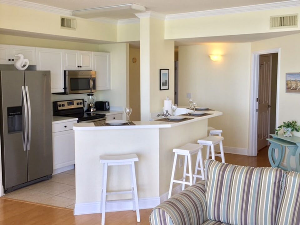 Fully stocked kitchen with breakfast bar.