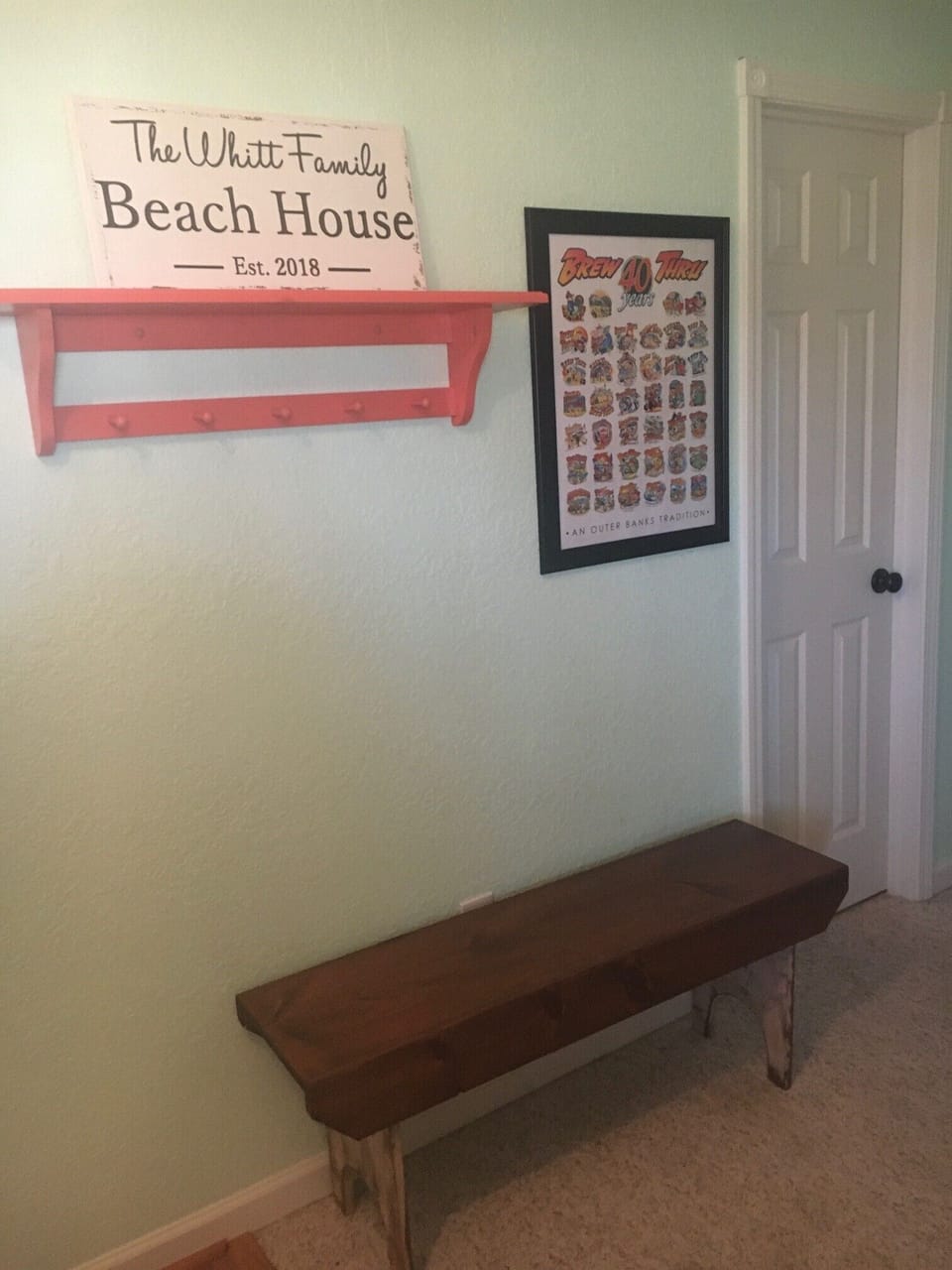 Entryway bench and door to downstairs full bathroom.