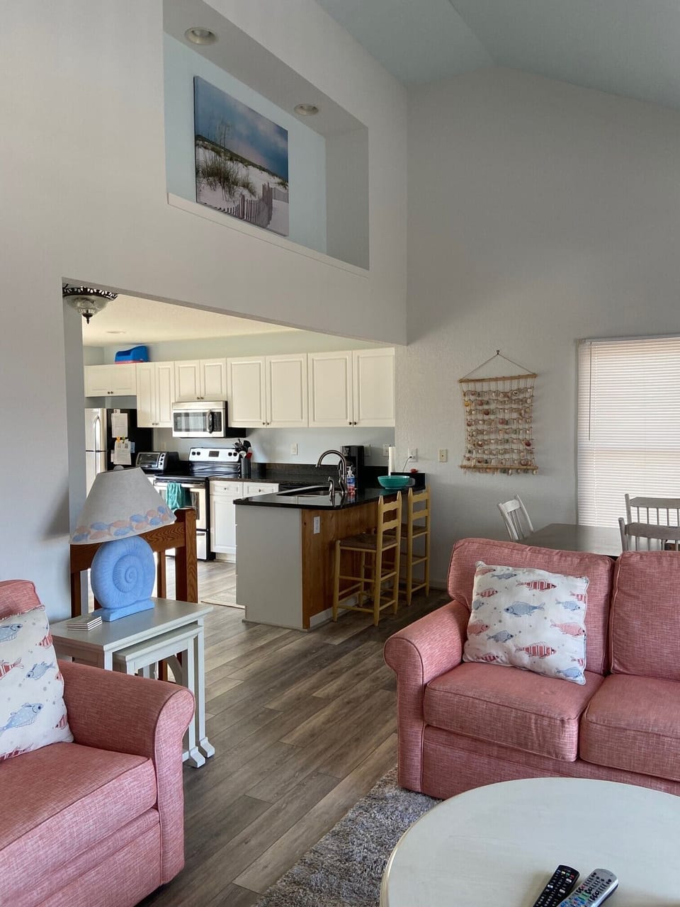 The large family room/eating area is open and airy with decks on front and back.