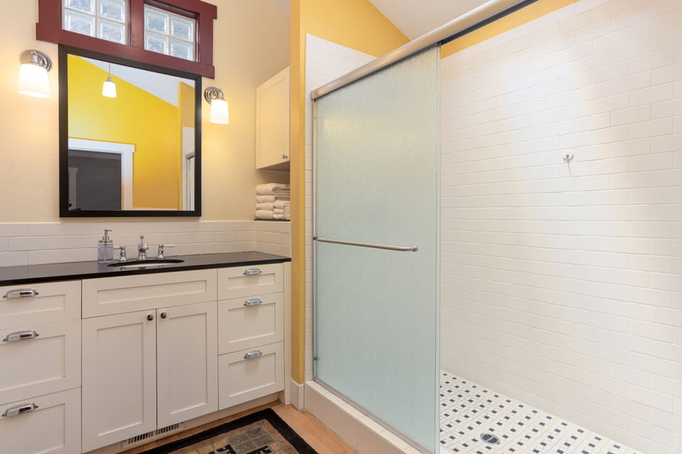 Bathroom attached to the king bedroom with vaulted ceiling and walk-in shower