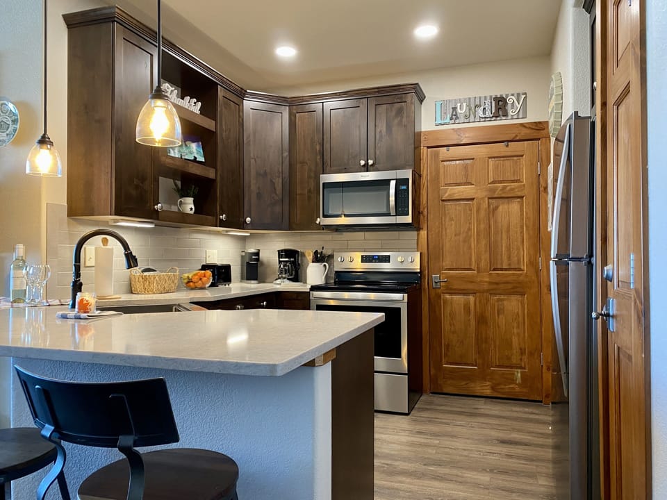 New kitchen: cabinetry, quartz counters, flooring, lighting, and appliances.