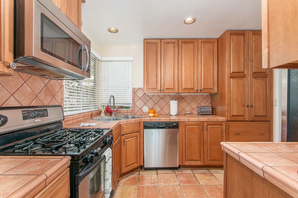 Kitchen with stainless steel appliances including microwave, dishwasher.  
