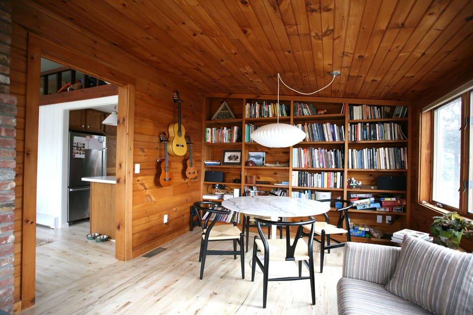SUN ROOM WITH WATER VIEWS AND FIREPLACE.  GAME TABLE WITH BOOKS, GAMES, ETC.