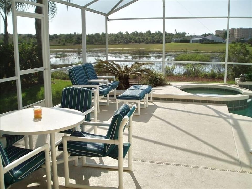 Outdoor eating/lounging area next to private pool/hot tub