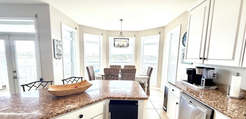 Kitchen featuring a dining table for 6 and additional island seating for 4.