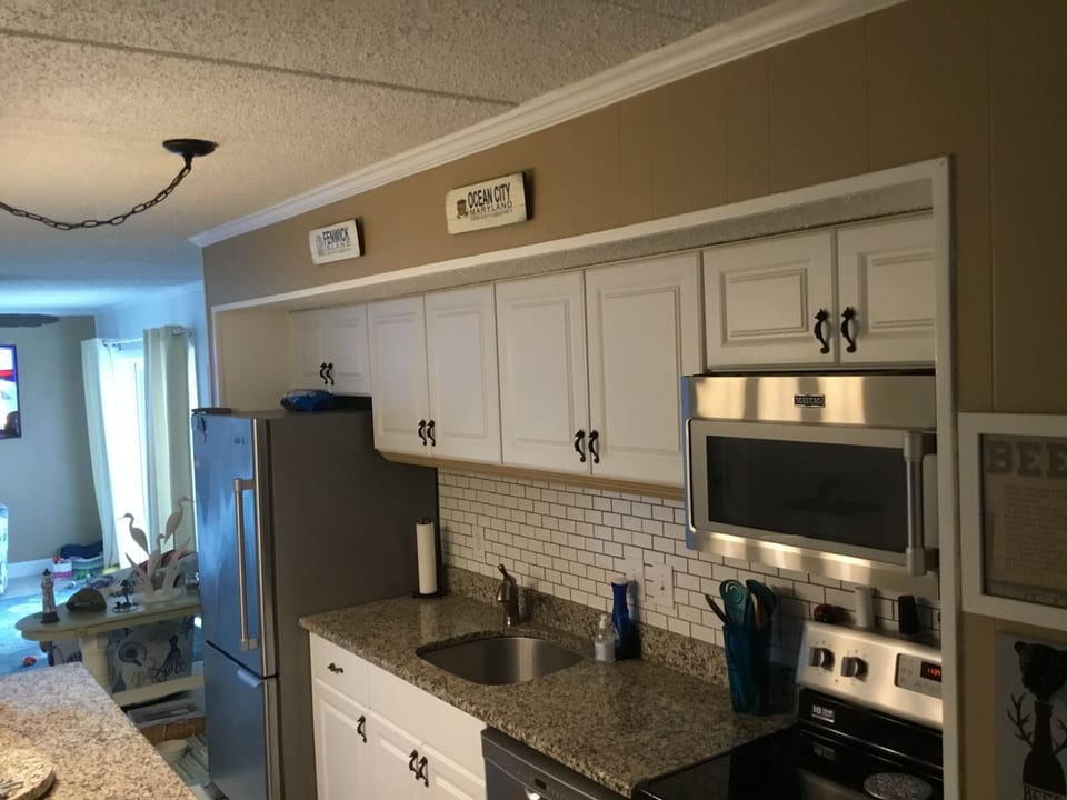 Freshly painted kitchen  providing all the utensils needed to prepare meals.