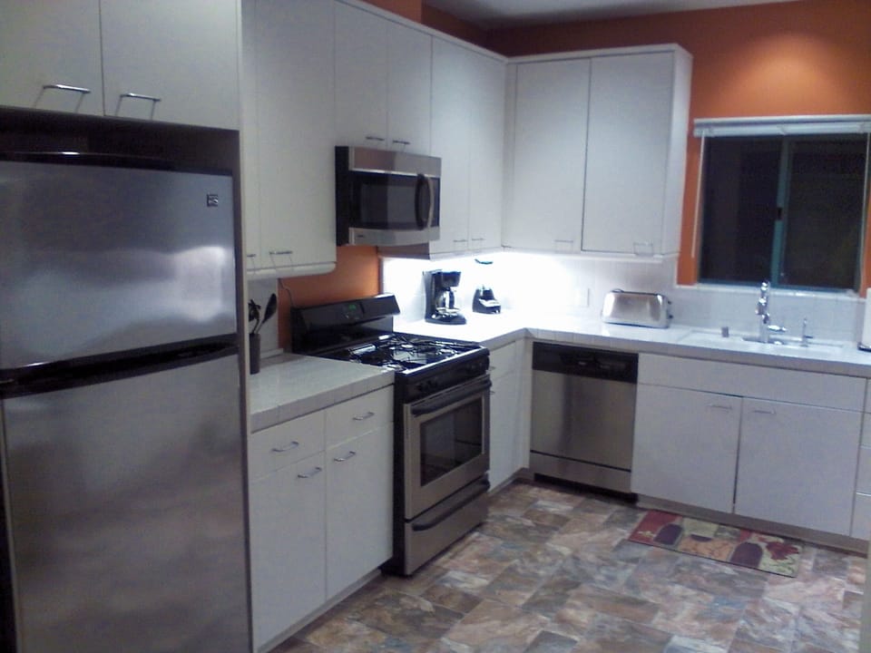 Hugh kitchen with all stainless steel appliances, new flooring.