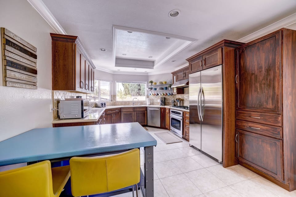 Kitchen flows into the dining room and there are sliders to the side yard