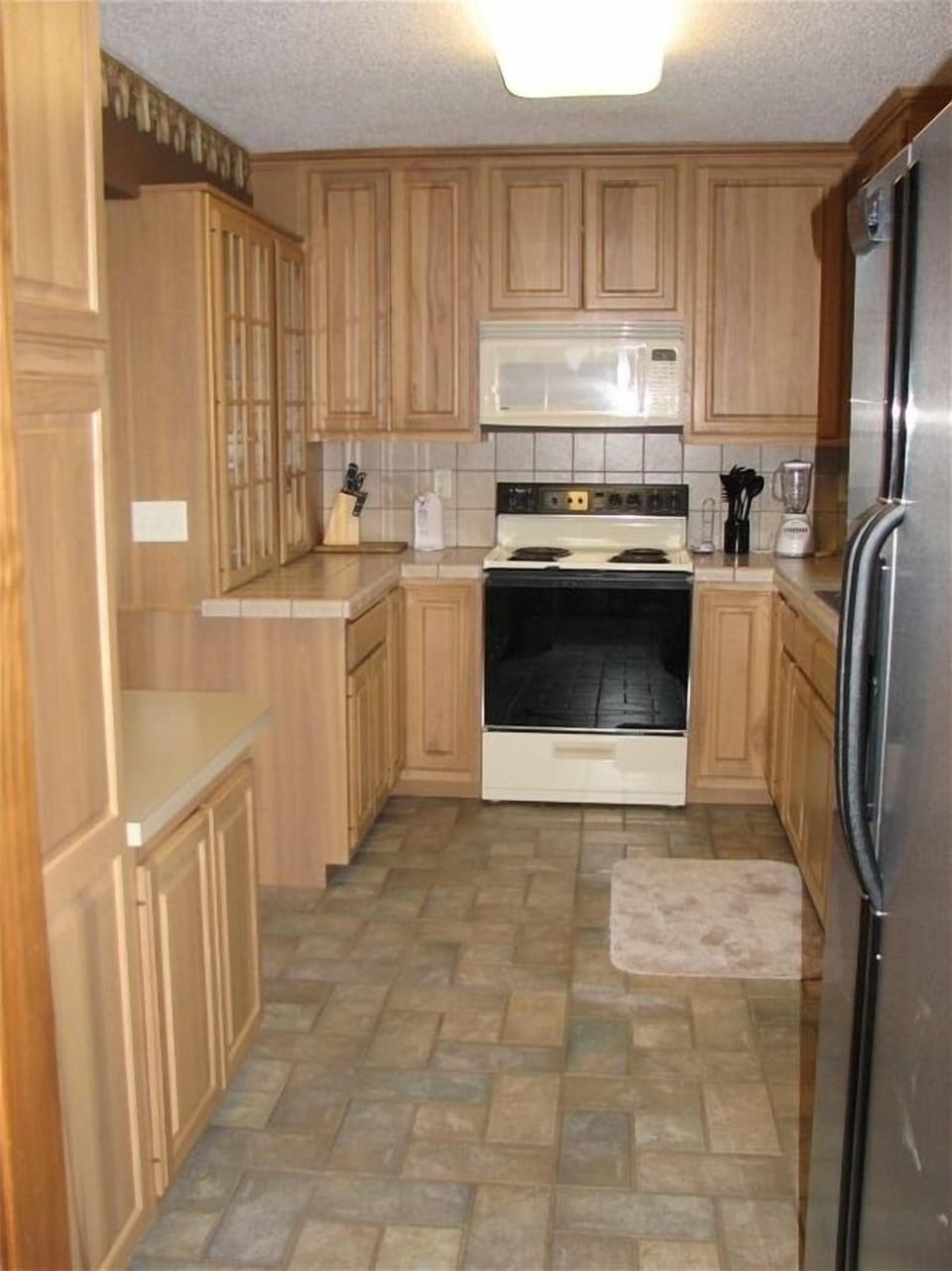 Completely furnished kitchen w/ tile floors and space to serve a large group.