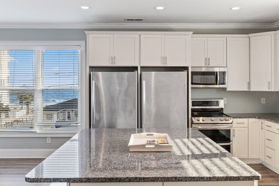 Enjoy family meals while at the beach. 

- Two fridges to store your meals and drinks 
- Gourmet stove with split ovens for dual temps
- Microwave for leftovers and popcorn 