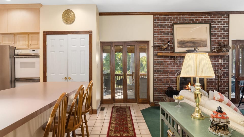 Kitchen is on left, pantry and SW screened porch ahead, living room on right.