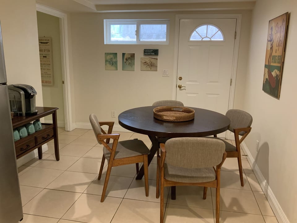 Dining room next to kitchen. Small breezeway is located outside with BBQ.