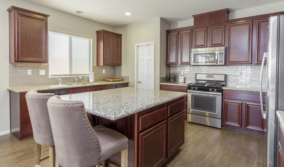 Kitchen with large island and plenty of wraparound counter space to cook