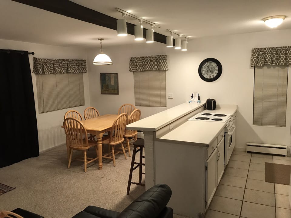 The Kitchen & bar with stove, dishwasher, microwave, fridge, and porcelain tile