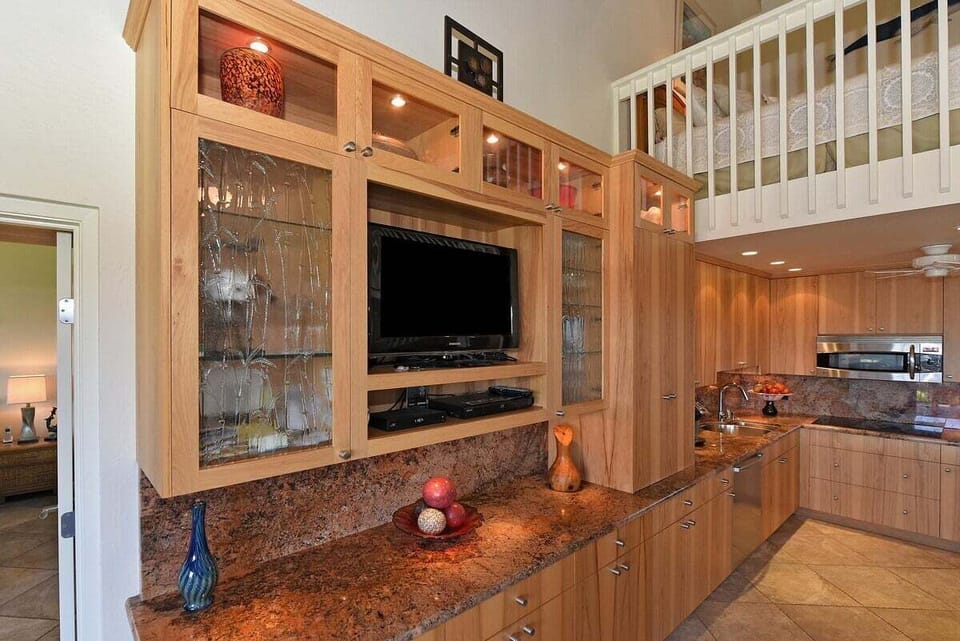 Cook in a spacious kitchen with granite counters and island seating.