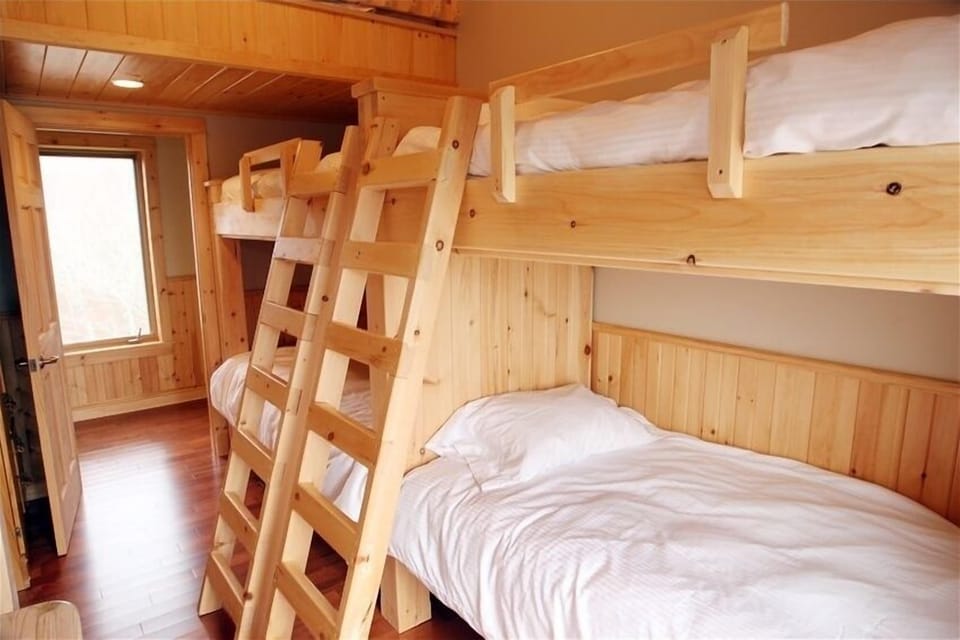 2 sets of bunk beds and a single loft bed
