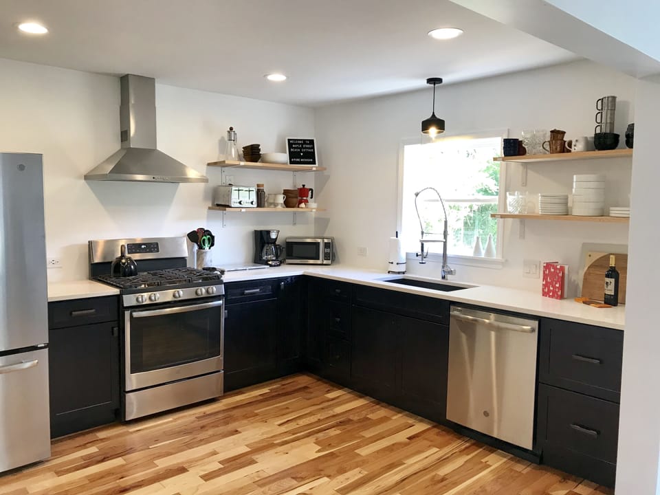 Kitchen fully stocked with pots, pans, dishes, utensils