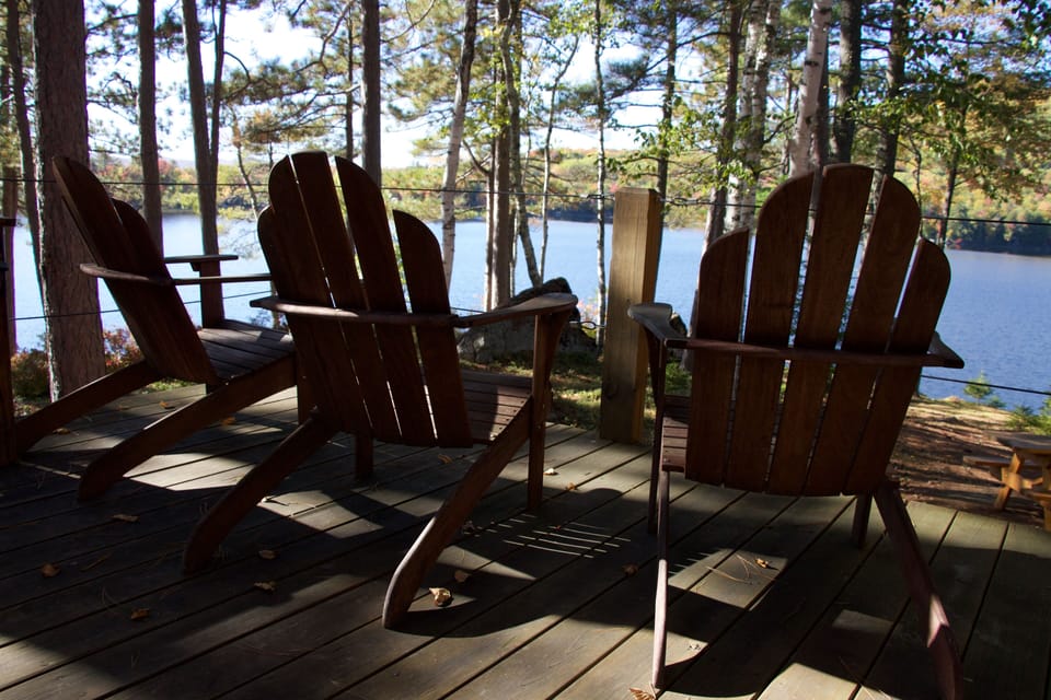 View from raised porch toward West and the fire pit area toward the water's edge