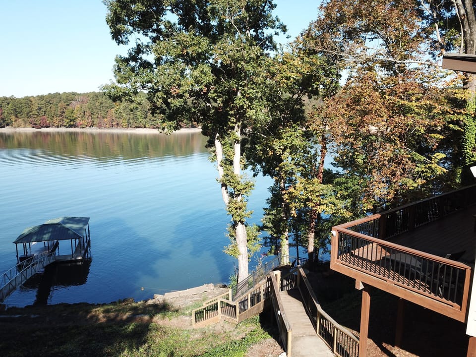 Deck overlooking walkway and lake.