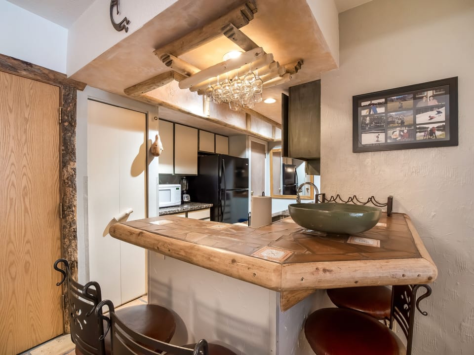 View of bar and kitchen.  Bar seats up to 4 people.