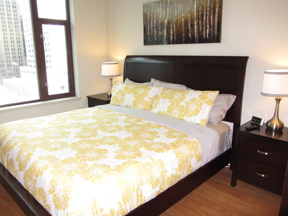 Master bedroom with king bed and city views