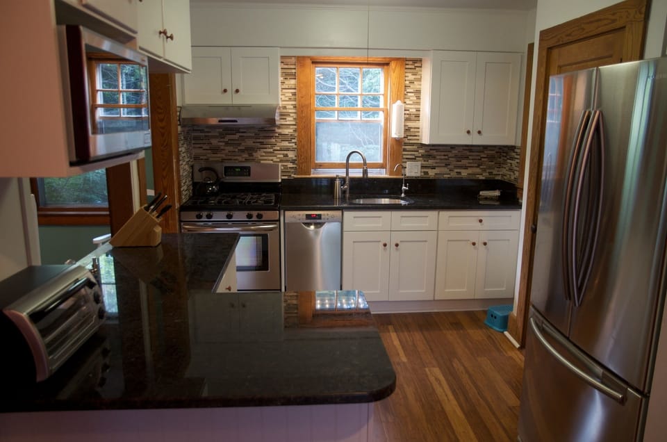 Kitchen with gas stove, granite counters, and everything you need