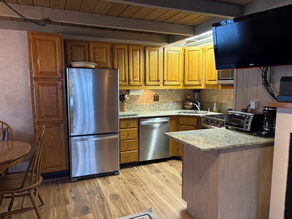 Kitchen with brand new stainless steel appliances and new flooring.