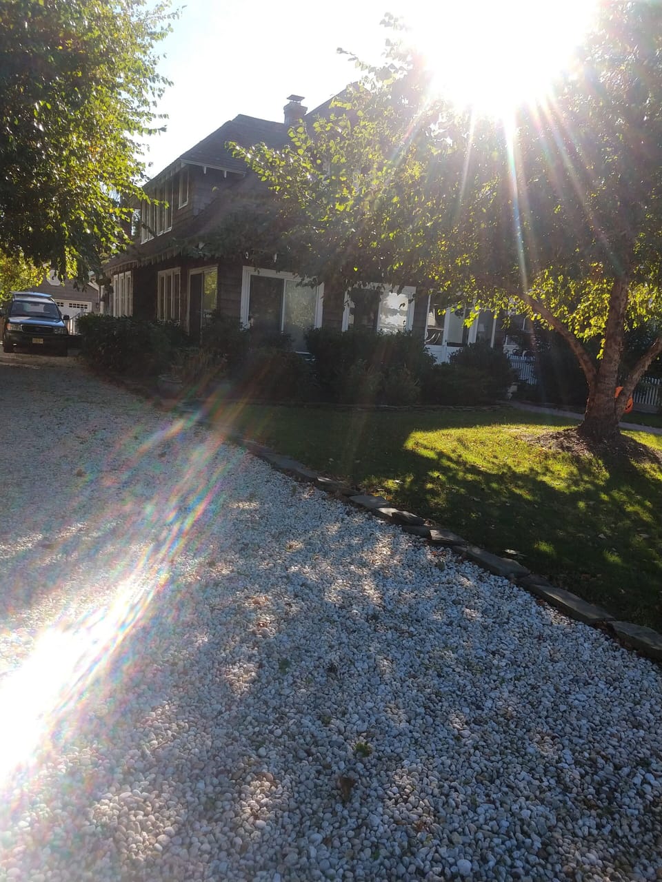 The pebbled driveway has lots of room for multiple cars.