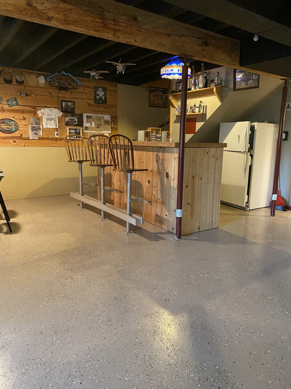 Basement bar with sink and second refrigerator.