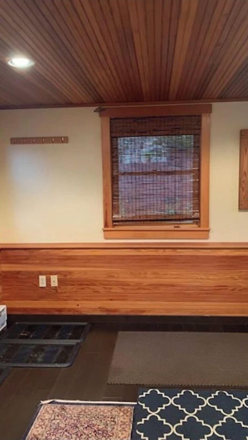 Mudroom off courtyard with plenty of hooks boot trays and ski racks 