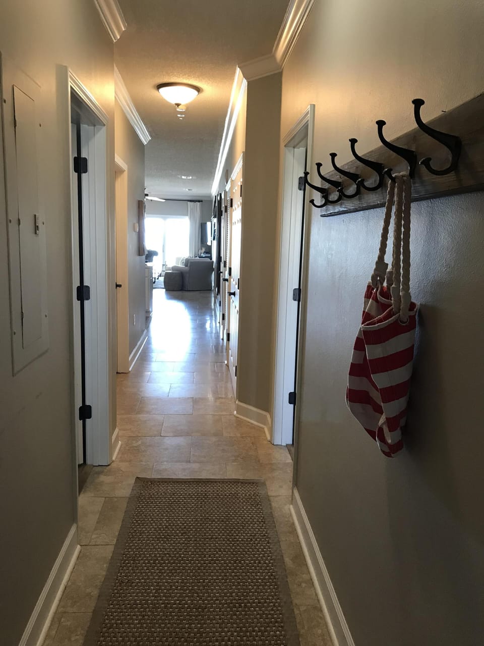 Entry to our home with seagrass runner and hat rack